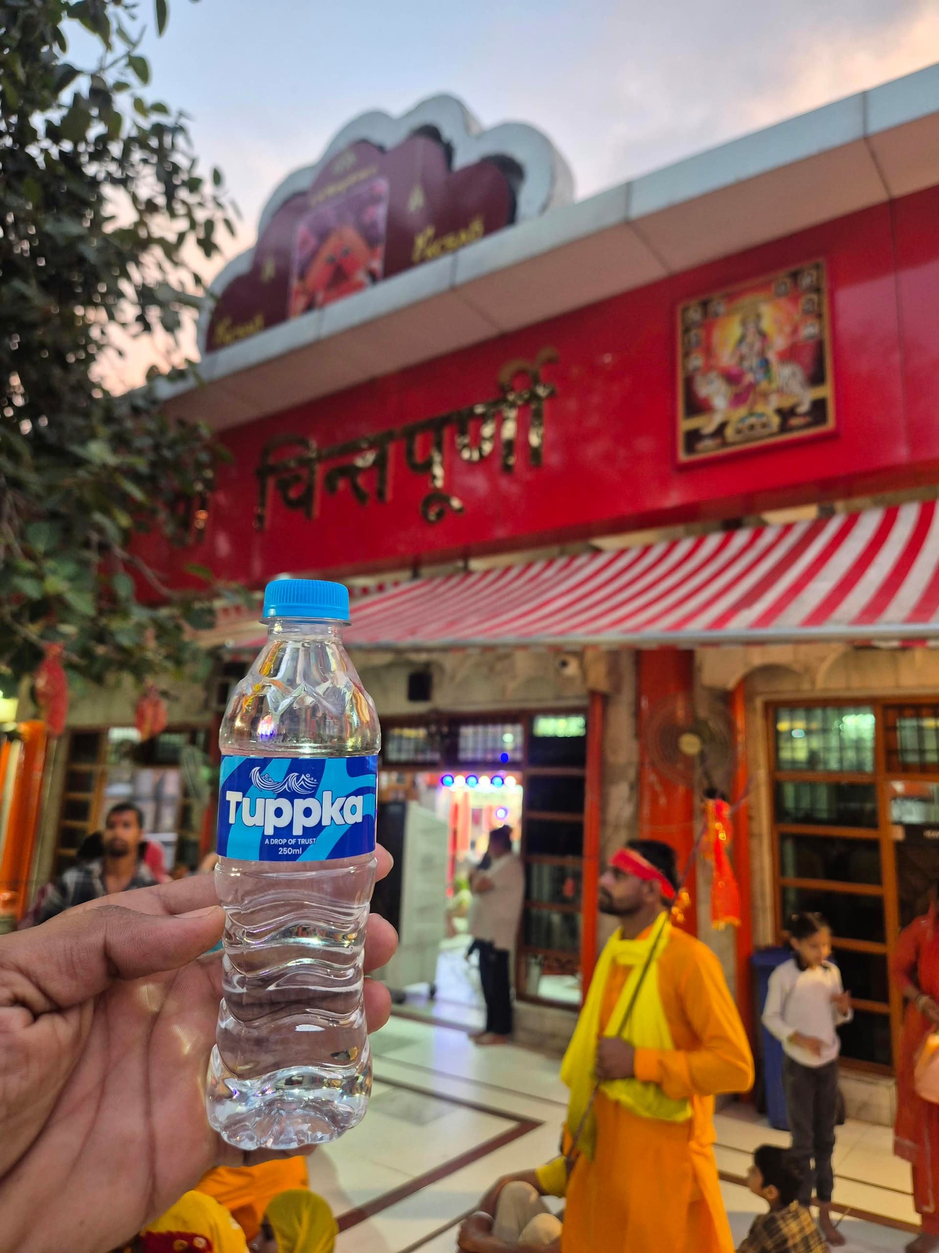 A bottle from the first Tuppka batch, held outside the Mata Chintpurni temple on the day of dedication.